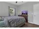 Bedroom features wood floors, dresser, and a window to bring natural light into the space at 1208 Baltimore Dr, Orlando, FL 32810