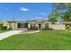 Charming single-story home with a green lawn, modern exterior, and curved walkway to the front door at 1208 Baltimore Dr, Orlando, FL 32810
