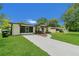 Charming home with well-maintained lawn, mature trees, and a curved walkway to the front door at 1208 Baltimore Dr, Orlando, FL 32810
