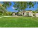Well-manicured lawn and landscaped front yard enhance the curb appeal of this inviting home at 1208 Baltimore Dr, Orlando, FL 32810