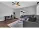 Cozy living room with neutral paint, hardwood floors, and a comfortable sectional sofa at 1208 Baltimore Dr, Orlando, FL 32810