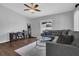 Cozy living room with neutral paint, hardwood floors, and a comfortable sectional sofa at 1208 Baltimore Dr, Orlando, FL 32810