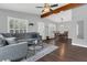 Open-concept living room features hardwood floors and leads into the dining area at 1208 Baltimore Dr, Orlando, FL 32810