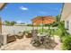 Inviting backyard patio area with cushioned seating, dining set under umbrella and string lights for evening enjoyment at 1208 Baltimore Dr, Orlando, FL 32810