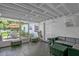 This enclosed patio features a ceiling, wood floors, and a gray lounge set at 1208 Baltimore Dr, Orlando, FL 32810