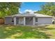 The home's fenced backyard with patio, windows, and grass at 122 Seville Rd, Auburndale, FL 33823