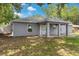 Inviting backyard featuring a covered patio and lush greenery, perfect for relaxation and outdoor gatherings at 122 Seville Rd, Auburndale, FL 33823