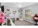 Bright bedroom features a sewing machine, white ceiling fan, and a large window at 122 Seville Rd, Auburndale, FL 33823