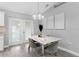 Charming dining area featuring a modern table, stylish chairs, and a view to the outdoors through French doors at 122 Seville Rd, Auburndale, FL 33823