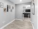 Cozy hallway leading into the living room, with light gray walls and wood-look flooring throughout at 122 Seville Rd, Auburndale, FL 33823