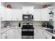 Beautiful kitchen featuring stainless steel appliances, bright white cabinets, and modern countertops at 122 Seville Rd, Auburndale, FL 33823