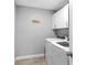 Functional laundry room with washer, dryer, white cabinets, and wood floors at 122 Seville Rd, Auburndale, FL 33823