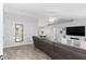 Open-concept living room featuring modern furnishings, wood-look flooring, and plenty of natural light at 122 Seville Rd, Auburndale, FL 33823