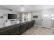 This spacious living room has a large sectional, light gray walls, wood-look flooring and a ceiling fan at 122 Seville Rd, Auburndale, FL 33823
