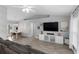 Open-concept living room featuring modern furnishings, wood-look flooring, and plenty of natural light at 122 Seville Rd, Auburndale, FL 33823
