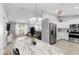 Spacious living area featuring an open layout, modern kitchen, and stylish dining space filled with natural light at 122 Seville Rd, Auburndale, FL 33823