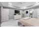 Comfortable main bedroom featuring a tray ceiling, generous closet space, and access to a modern ensuite bathroom at 122 Seville Rd, Auburndale, FL 33823