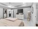 Bright main bedroom with a tray ceiling, featuring lots of space, a large dresser and access to the ensuite bathroom at 122 Seville Rd, Auburndale, FL 33823