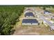 Aerial view of new single-Gathering home construction with wooded green space in the background at 1249 Champions Dr, Daytona Beach, FL 32124