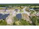 Aerial view of new single-Gathering home construction near a golf course and lake community at 1249 Champions Dr, Daytona Beach, FL 32124
