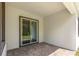Covered back porch with brick flooring, adjacent to grassy backyard at 1249 Champions Dr, Daytona Beach, FL 32124