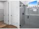 Modern bathroom featuring tiled walk-in shower and adjacent linen closet and door at 1249 Champions Dr, Daytona Beach, FL 32124
