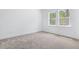 Bright bedroom with neutral carpet and large windows offering natural light at 1249 Champions Dr, Daytona Beach, FL 32124