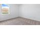 Bright bedroom featuring neutral carpet, base trim, and a single window at 1249 Champions Dr, Daytona Beach, FL 32124