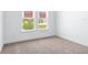 Bright bedroom features a large window and plush carpeting at 1249 Champions Dr, Daytona Beach, FL 32124