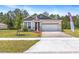 Charming single-Gathering home featuring manicured lawn, brick-paved driveway, and welcoming exterior at 1249 Champions Dr, Daytona Beach, FL 32124