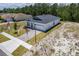New construction shows a single-story home with brick driveway and lawn on a sunny day at 1249 Champions Dr, Daytona Beach, FL 32124