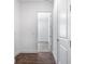 Hallway with wood-look floors leading to carpeted bedroom at 1249 Champions Dr, Daytona Beach, FL 32124