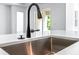 Close up of kitchen sink with stainless faucet, sink and quartz countertop at 1249 Champions Dr, Daytona Beach, FL 32124