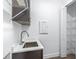 Laundry room features a gray vanity, stainless steel sink and wire shelving at 1249 Champions Dr, Daytona Beach, FL 32124