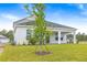 A tranquil backyard with a well-kept lawn and partially covered patio, perfect for outdoor enjoyment and entertaining at 1262 Champions Dr, Daytona Beach, FL 32124