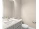 Modern half-bathroom featuring a gray vanity with white countertop and modern fixtures at 1262 Champions Dr, Daytona Beach, FL 32124