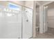 Bright bathroom featuring a glass-enclosed shower with white tile at 1262 Champions Dr, Daytona Beach, FL 32124