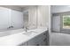 Bathroom vanity featuring a white counter and gray cabinets at 1262 Champions Dr, Daytona Beach, FL 32124