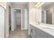 Bathroom featuring double vanity, a large mirror, and tiled floors at 1262 Champions Dr, Daytona Beach, FL 32124