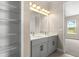 Bright bathroom features a double sink vanity with modern fixtures and a spacious walk-in closet at 1262 Champions Dr, Daytona Beach, FL 32124
