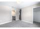 Bedroom with neutral walls, carpet, and doorways to bathroom and closet at 1262 Champions Dr, Daytona Beach, FL 32124