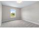 Bedroom with view, carpeted floor, and neutral-colored walls at 1262 Champions Dr, Daytona Beach, FL 32124