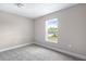 Bright bedroom features a window with a view to the neighborhood at 1262 Champions Dr, Daytona Beach, FL 32124
