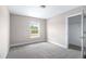 A bright bedroom shows a window with a view and an open closet at 1262 Champions Dr, Daytona Beach, FL 32124