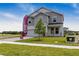 Charming two-story home with gray siding, stone accents, and a well-manicured lawn at 1262 Champions Dr, Daytona Beach, FL 32124