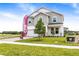 Charming two-story home featuring a two-car garage, stone accents, and a well-manicured front lawn at 1262 Champions Dr, Daytona Beach, FL 32124