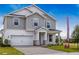 Stunning two-story home featuring gray siding, stone accents, and a two-car garage at 1262 Champions Dr, Daytona Beach, FL 32124
