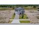 New two-story home showcasing manicured lawn, elegant driveway, and a welcoming front entrance with a covered porch at 1262 Champions Dr, Daytona Beach, FL 32124