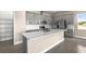 Stylish kitchen featuring gray cabinets, stainless steel appliances, and a quartz countertop island at 1262 Champions Dr, Daytona Beach, FL 32124