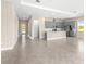 Bright, open kitchen with gray cabinets, stainless steel appliances, and a spacious island at 1262 Champions Dr, Daytona Beach, FL 32124